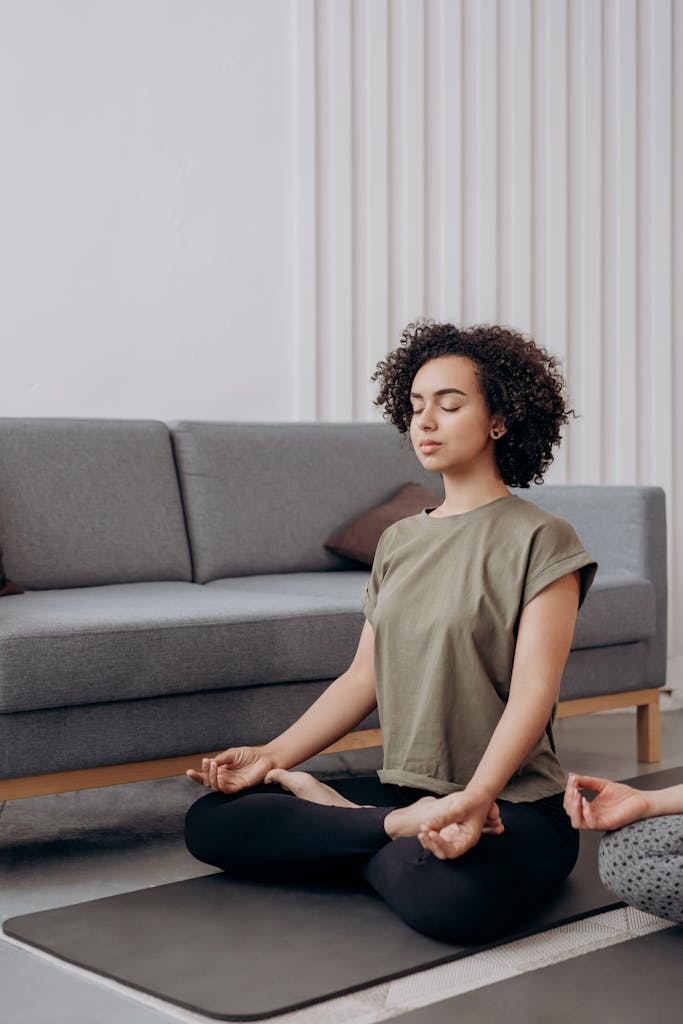 Relaxed young woman meditating indoors for a healthy lifestyle.